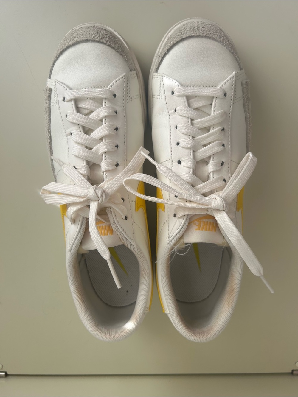 Nike White Low-Top Sneakers with Yellow Swoosh